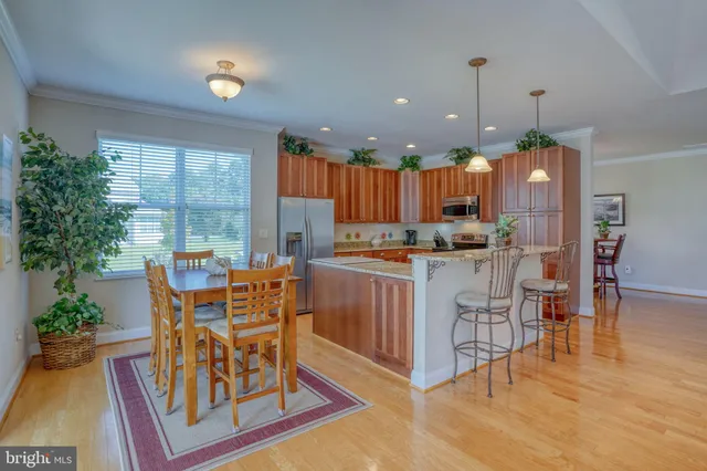 a view of a backyard with table and chairs potted plants and a fire pit