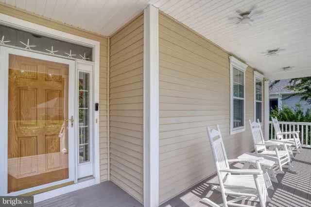 a hallway with wooden floor and potted plant