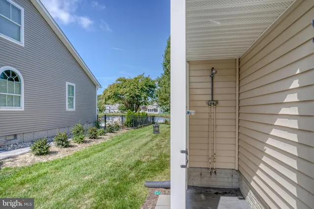 a bathroom with a sink a toilet a mirror and shower