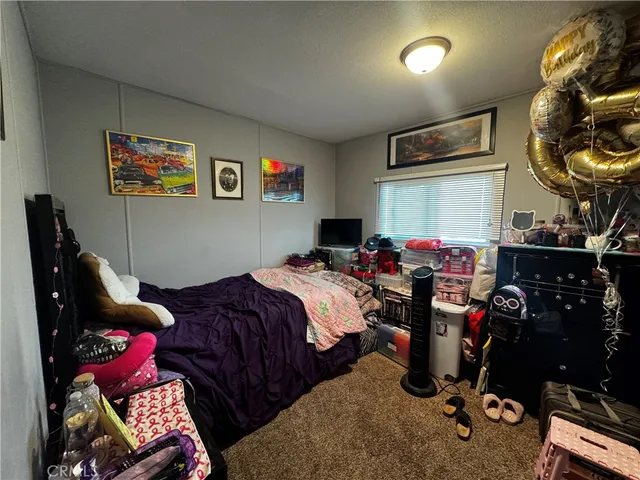 a bedroom with bed and a closet