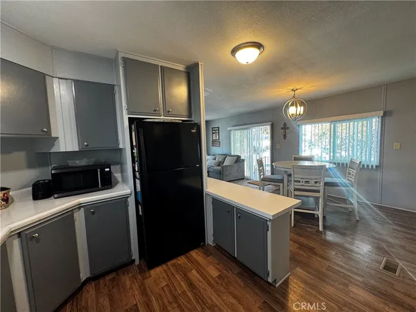 a kitchen with a sink a counter top space stainless steel appliances and cabinets