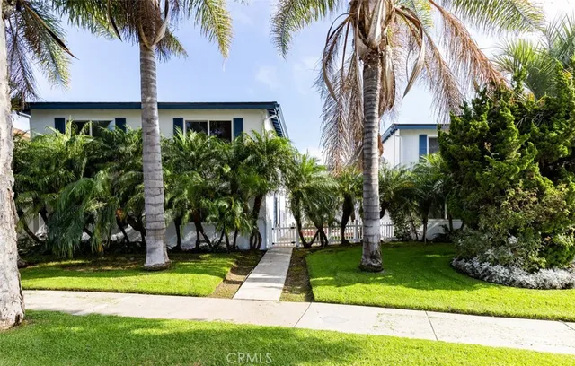 a front view of multi story residential apartment building with yard and green space