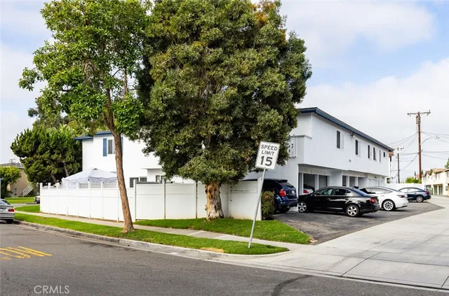 a car parked in front of white building