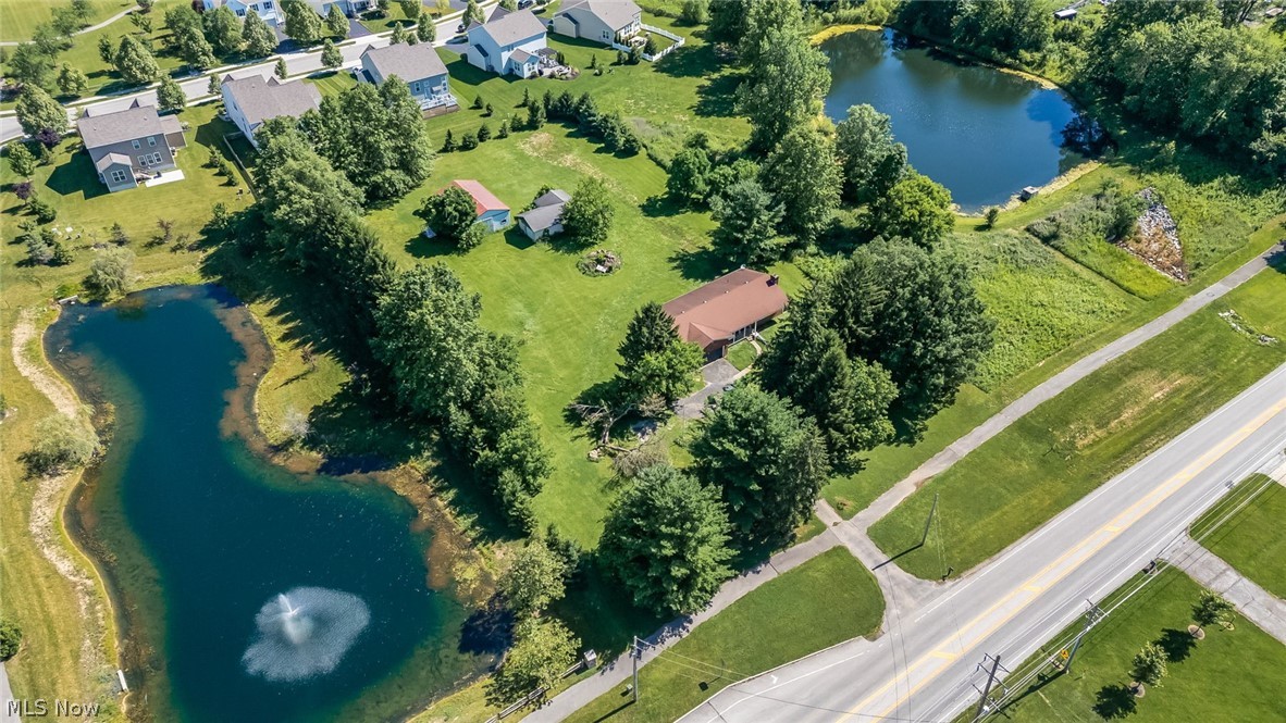 6890 Refugee Road Pickerington, OH 43147 - Photo 43 of 49 Aerial property overview featuring a single-story residence with a brown roof, surrounded by mature trees and expansive green space