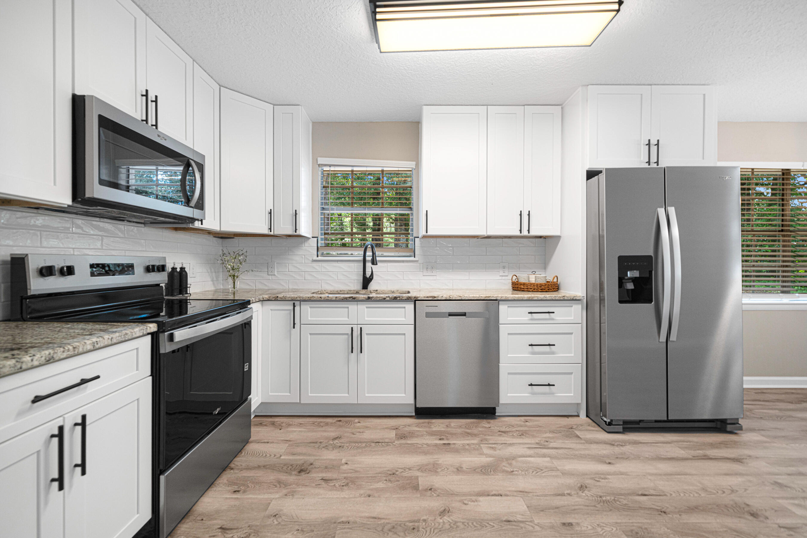 a kitchen with granite countertop cabinets and steel stainless steel appliances