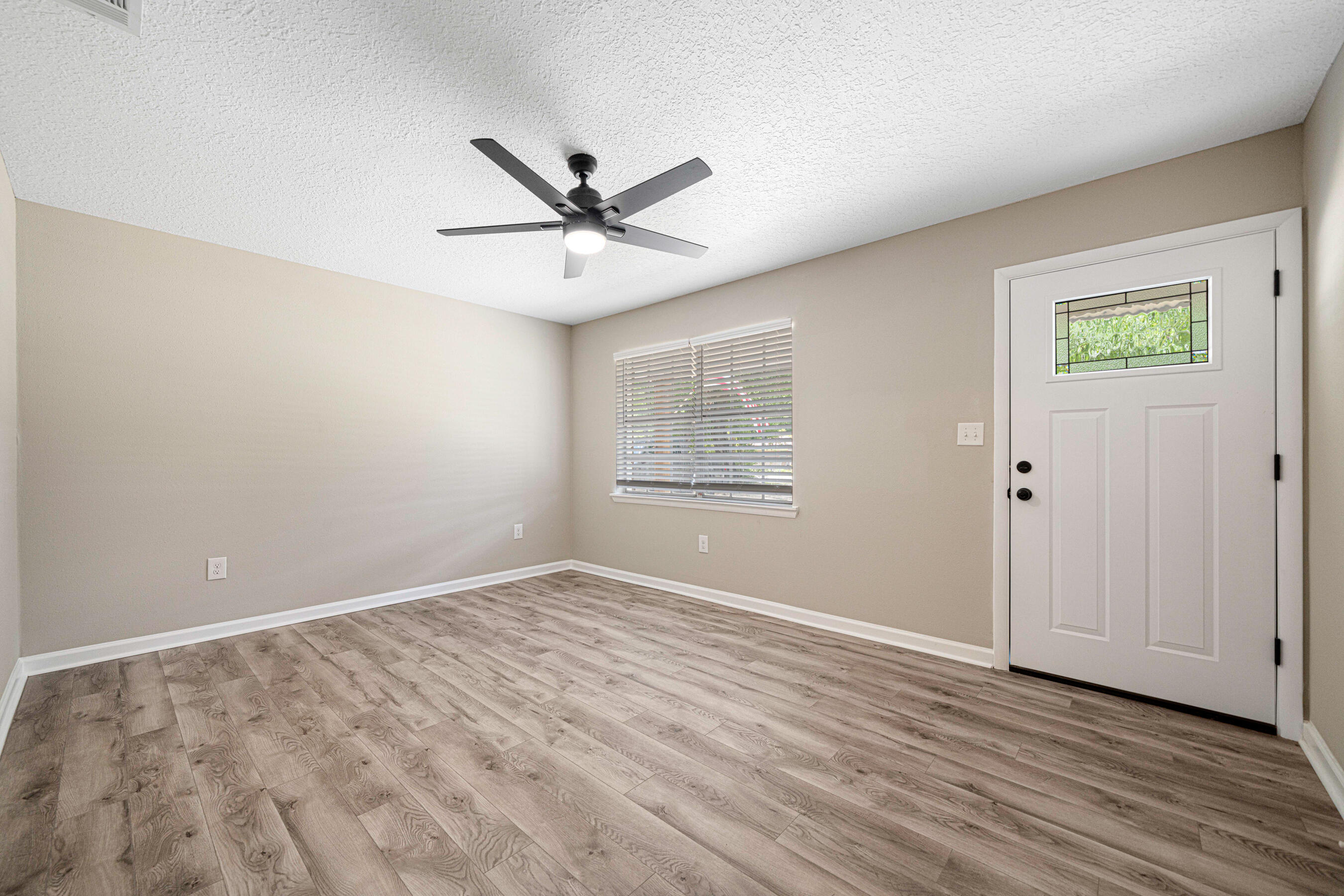 207 Oglesby Avenue Crestview, FL 32536 - Photo 11 of 30 a view of empty room with wooden floor