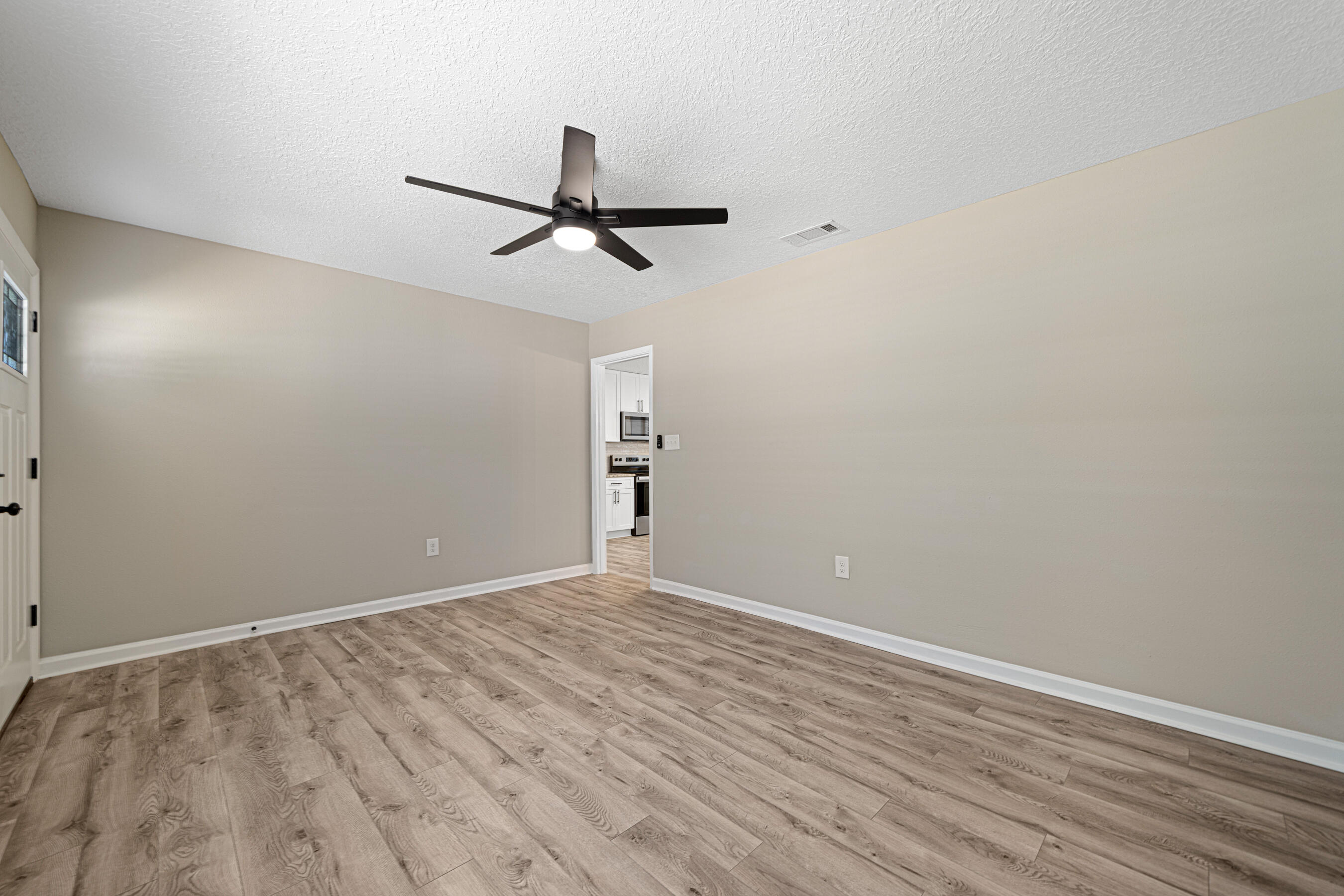 207 Oglesby Avenue Crestview, FL 32536 - Photo 15 of 30 wooden floor in an empty room