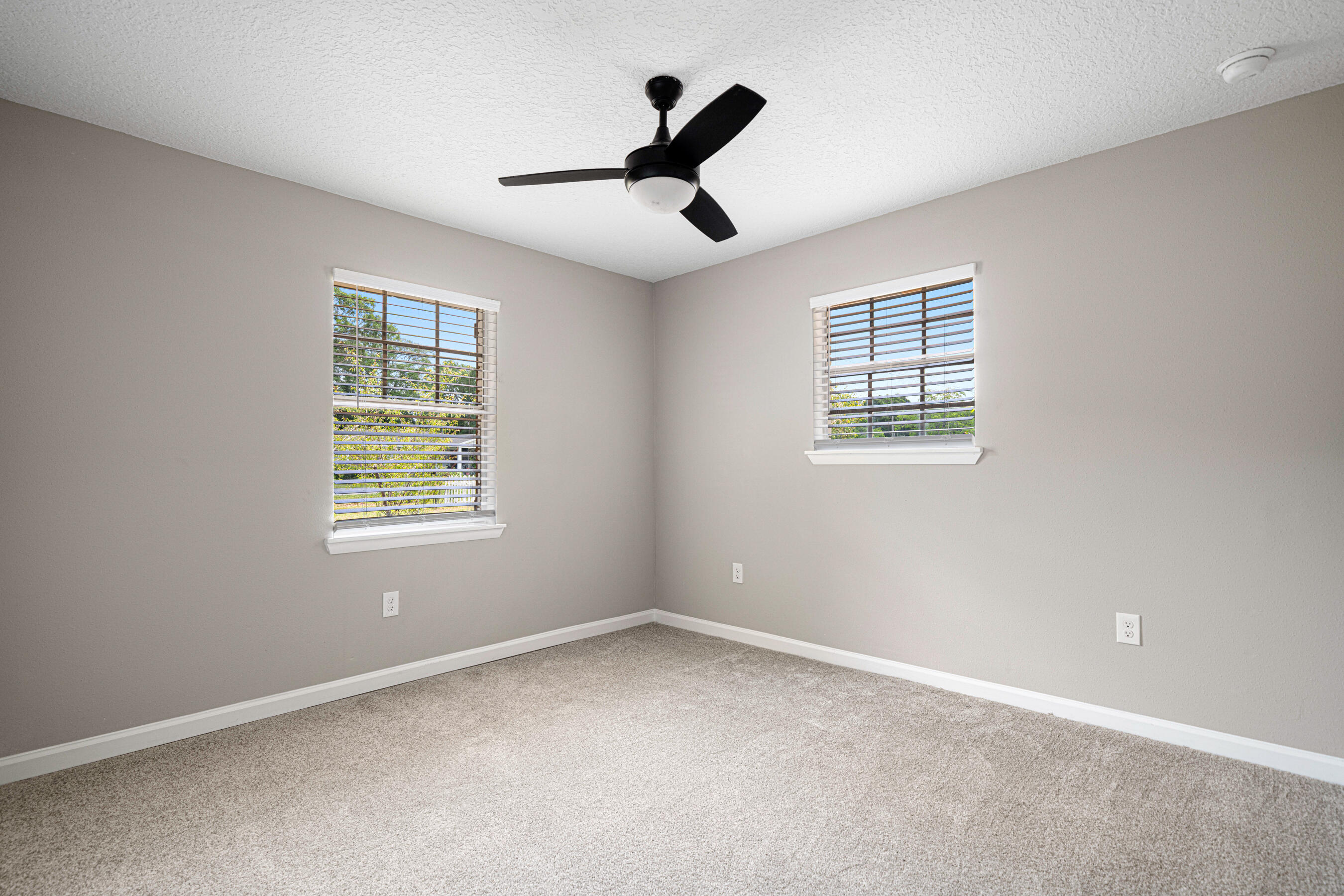 207 Oglesby Avenue Crestview, FL 32536 - Photo 18 of 30 an empty room with ceiling fan and window
