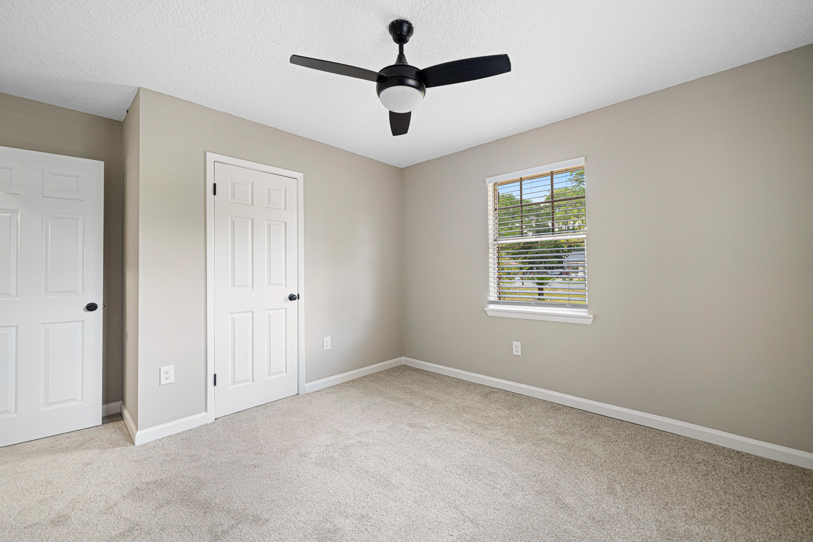 207 Oglesby Avenue Crestview, FL 32536 - Photo 19 of 30 wooden floor in an empty room with a window