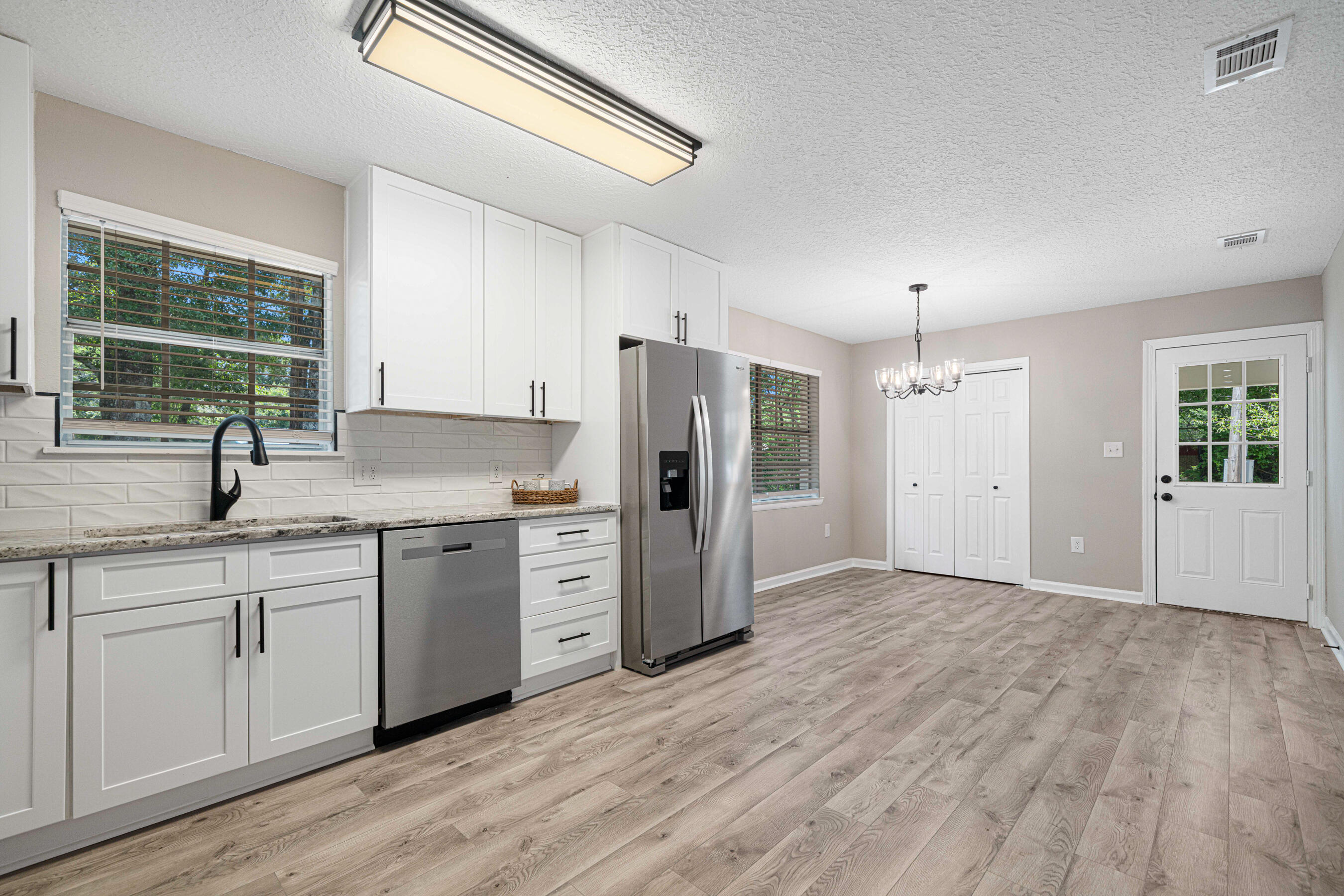 207 Oglesby Avenue Crestview, FL 32536 - Photo 8 of 30 a kitchen with granite countertop a refrigerator and a sink