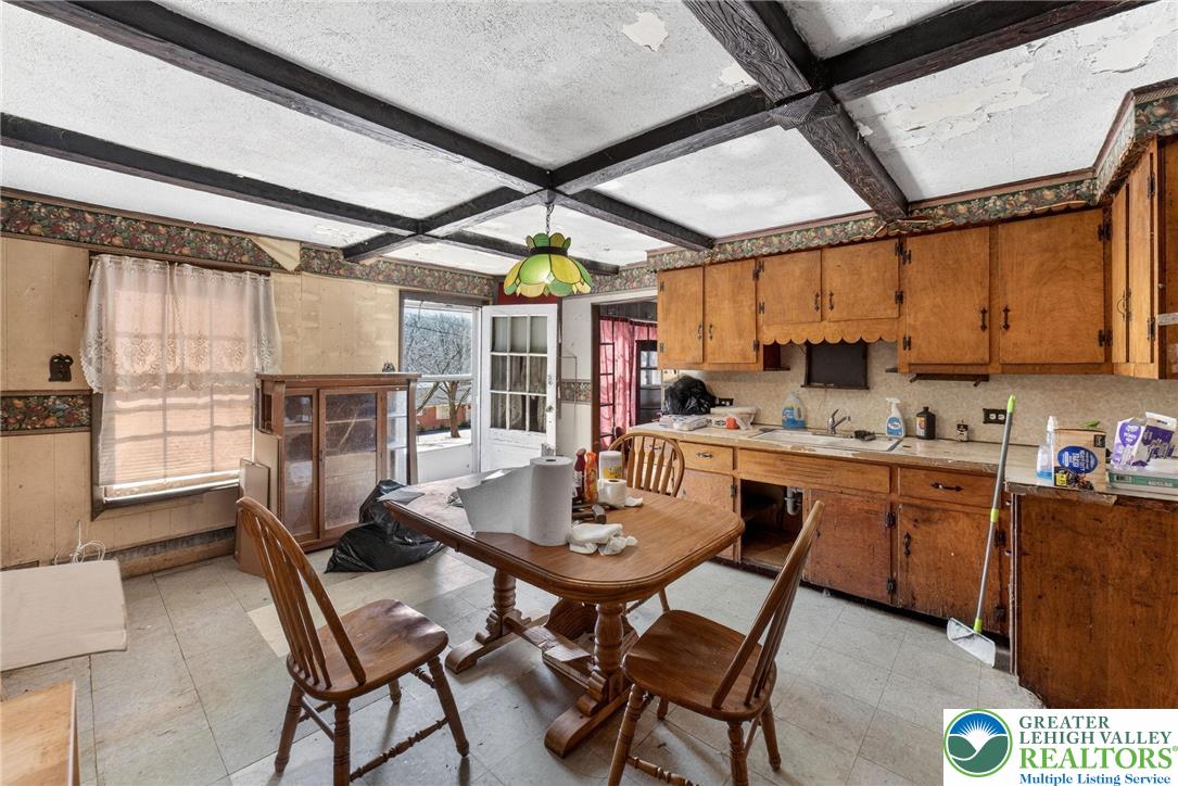 455 Morvale Road Easton, PA 18042 - Photo 16 of 47 a kitchen with a dining table chairs and white cabinets
