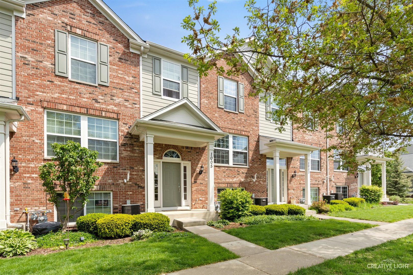 1005 Crane Point Elgin, IL 60124 - Photo 1 of 18 front view of a brick house with a yard