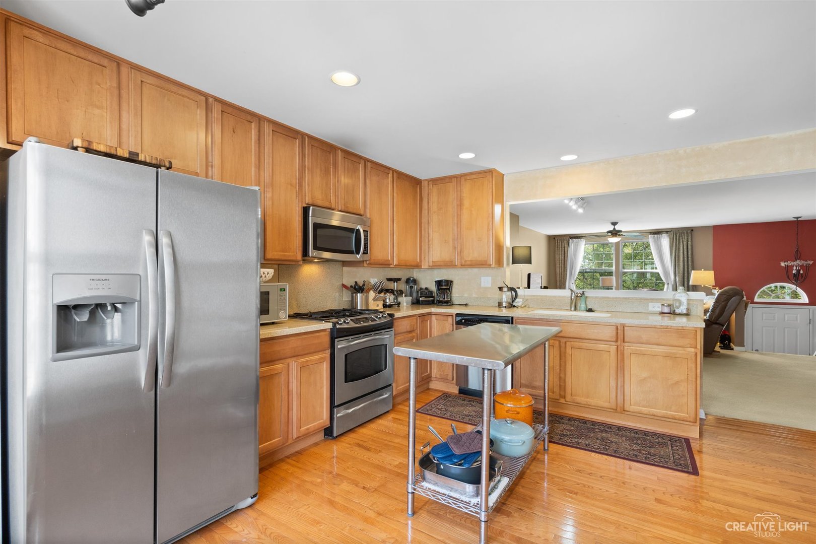 1005 Crane Point Elgin, IL 60124 - Photo 8 of 18 a kitchen with stainless steel appliances granite countertop a refrigerator a stove top oven a sink dishwasher and chairs with wooden floor