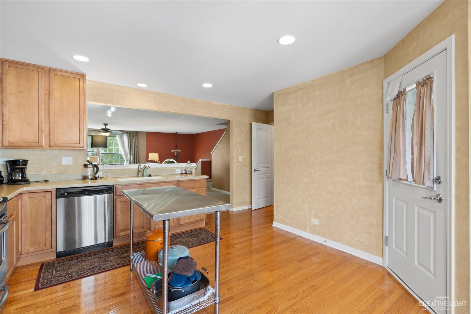 1005 Crane Point Elgin, IL 60124 - Photo 9 of 18 a kitchen with stainless steel appliances granite countertop a refrigerator a sink dishwasher and a dining table with wooden floor