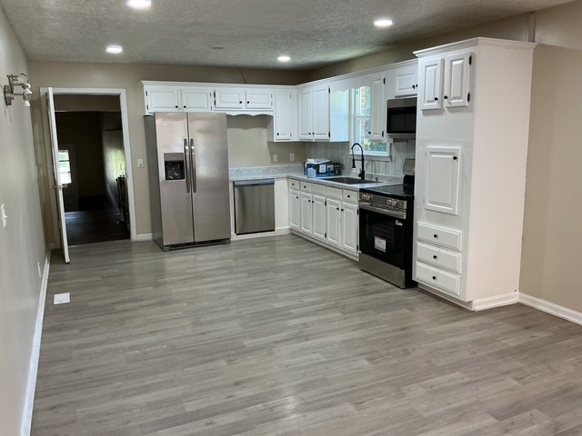 2000 Fairview Boulevard Fairview, TN 37062 - Photo 9 of 35 a kitchen with stainless steel appliances a refrigerator sink and cabinets
