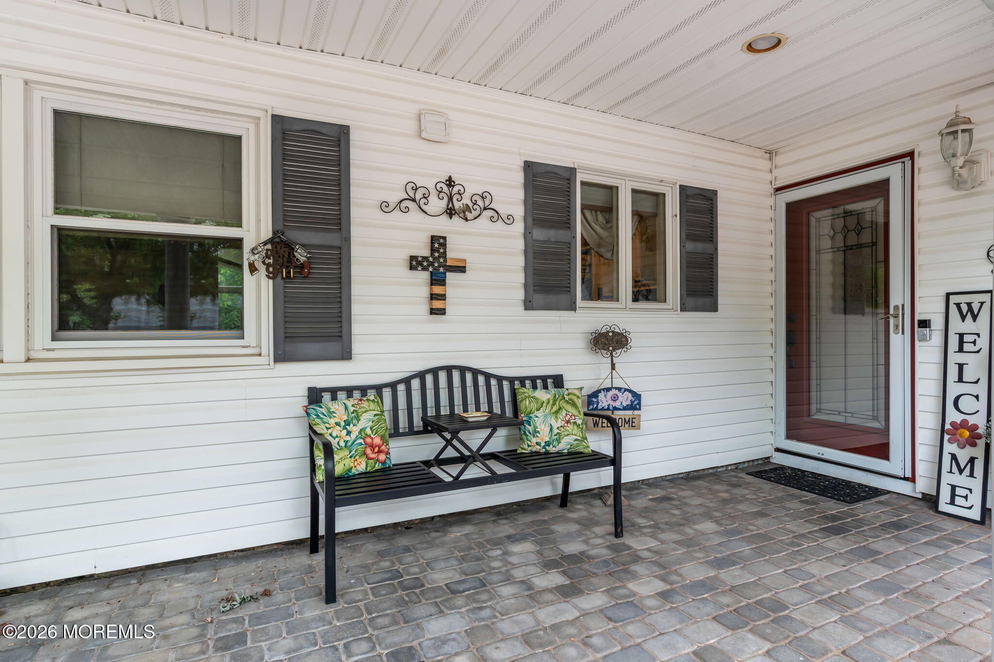 8 Owens Road Marlboro, NJ 07746 - Photo 5 of 39 a bench sitting in front of a house