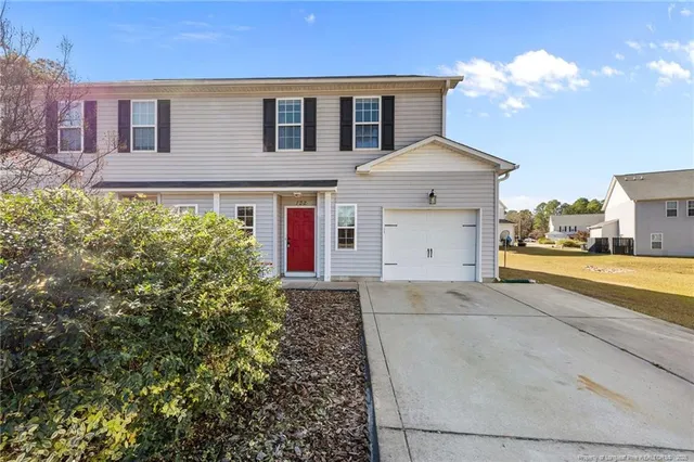 a front view of a house with a yard and garage