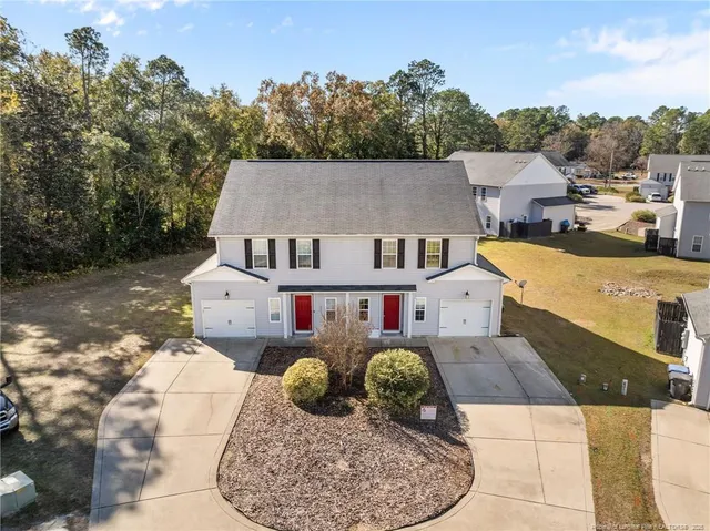 an aerial view of a swimming pool with outdoor seating