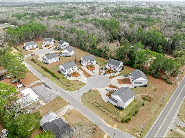 an aerial view of a house with a yard