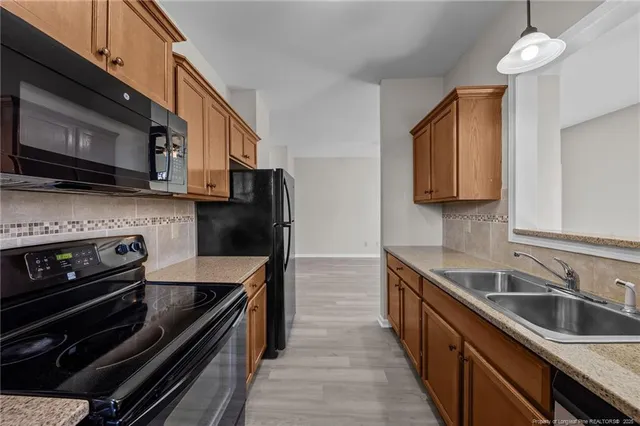a kitchen with stainless steel appliances a stove cabinets and a sink