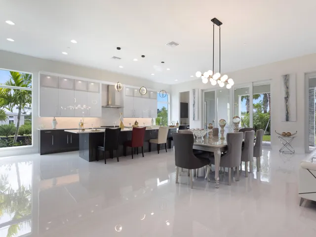a kitchen with stainless steel appliances kitchen island a sink and a large mirror