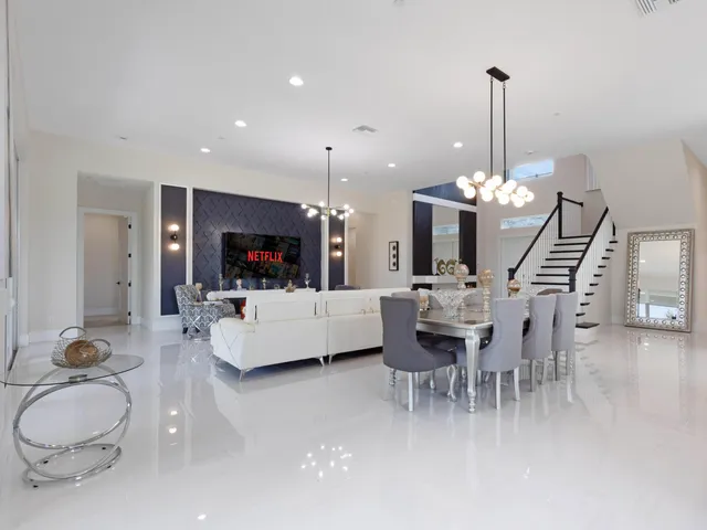 a kitchen with stainless steel appliances kitchen island a sink and a large mirror