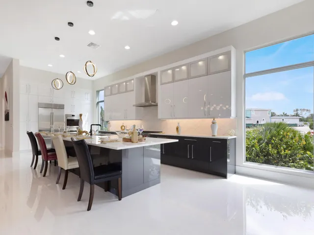 a large kitchen with a table and chairs