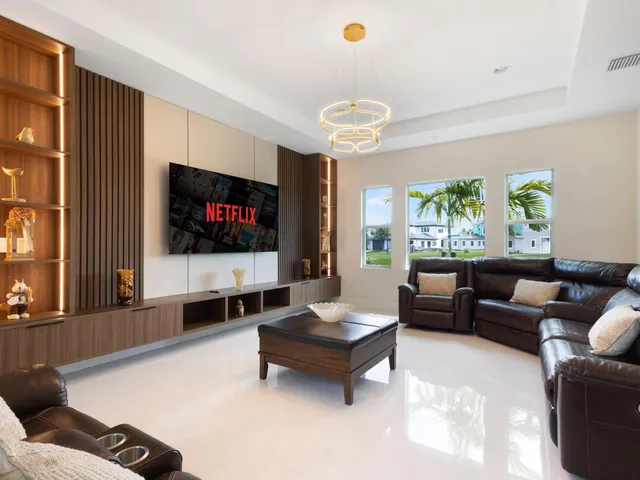 a bathroom with a sink mirror and a potted plant
