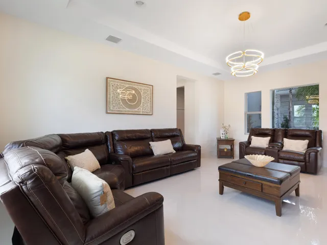a view of kitchen with stainless steel appliances kitchen island granite countertop a sink and cabinets