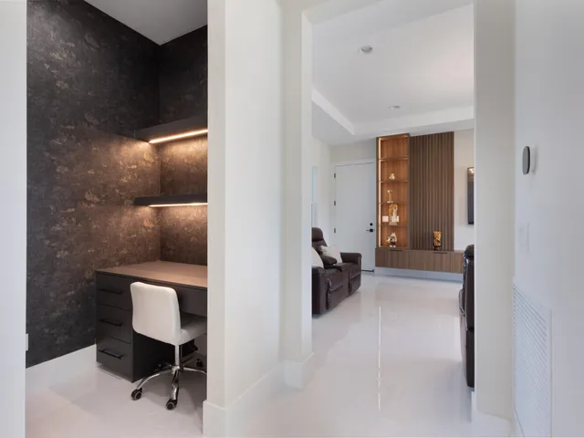 a bedroom with a bed and a table chair