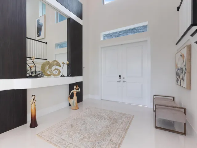 a living room with furniture a chandelier and a flat screen tv