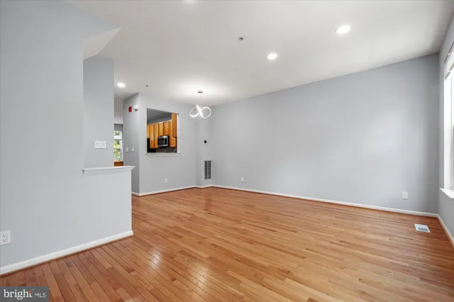 a kitchen with stainless steel appliances granite countertop a refrigerator a stove and a sink