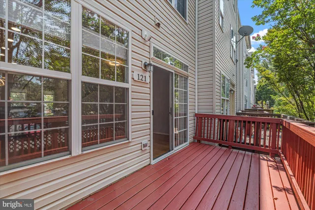 a balcony with wooden floor and fence