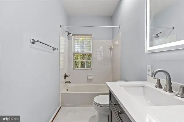 a view of a livingroom with a ceiling fan and window