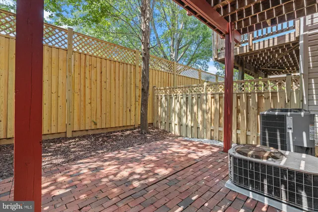 a view of a house with a big yard and large trees