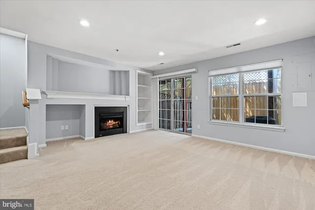 a view of an empty room with a fireplace