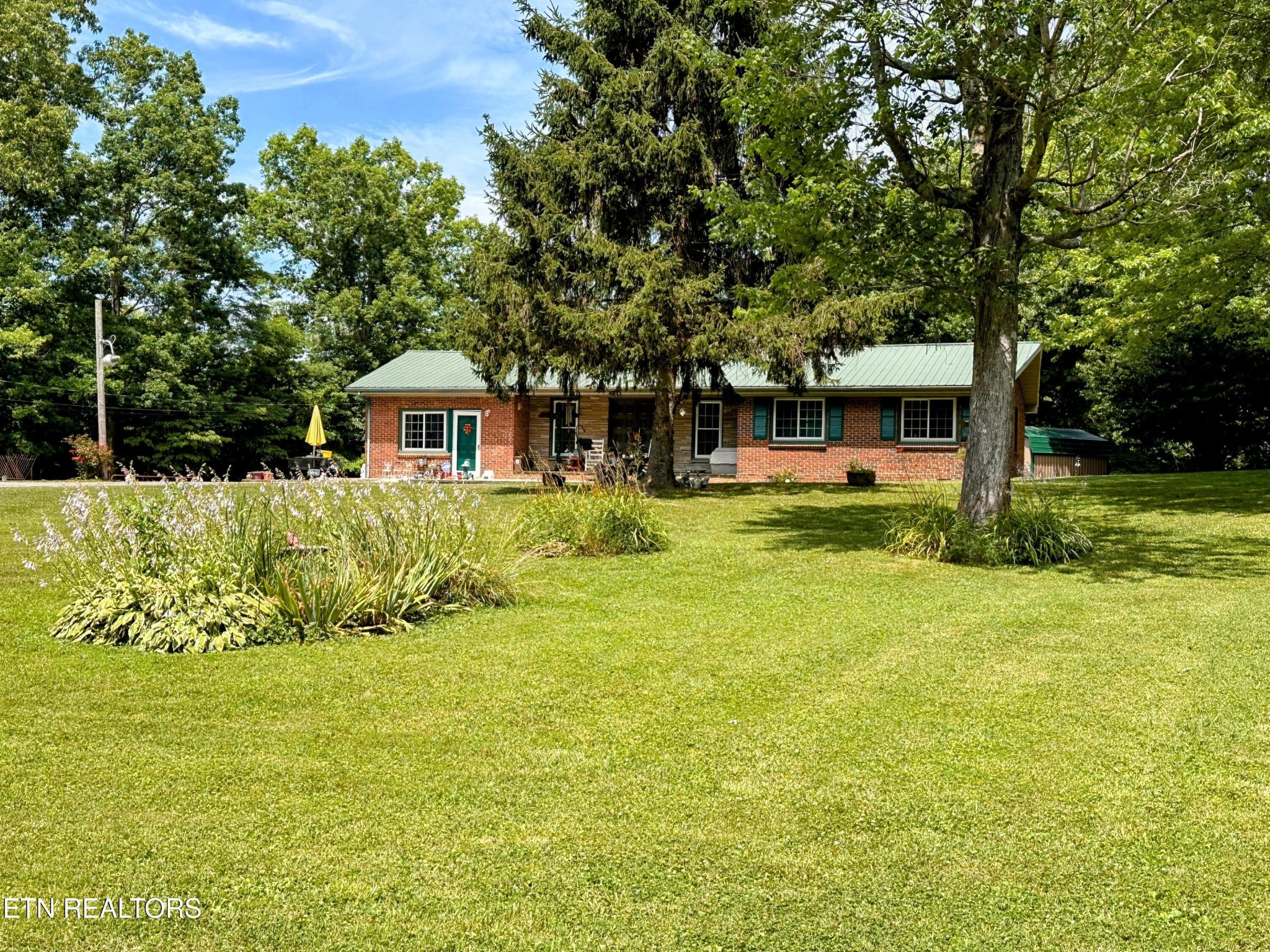 1065 Star Point Road Jamestown, TN 38556 - Photo 1 of 40 a front view of a house with a yard table and chairs