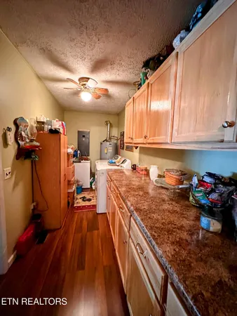 a kitchen with granite countertop lots of counter top space and wooden floor