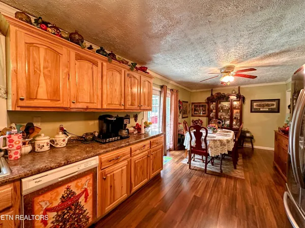 a kitchen with granite countertop lots of counter top space and wooden floor