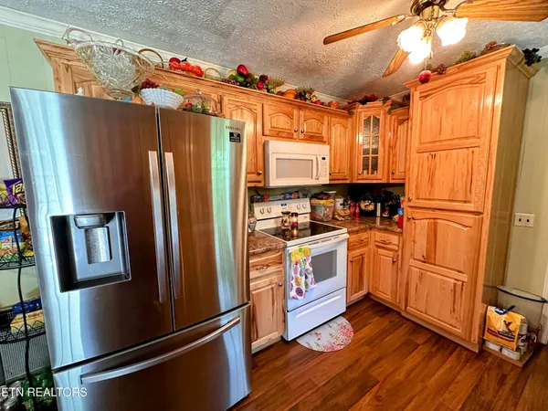 a kitchen with stainless steel appliances a refrigerator sink and microwave
