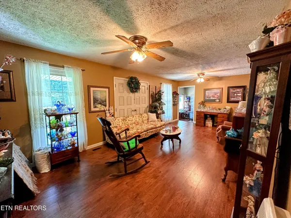 a living room with furniture and a wooden floor