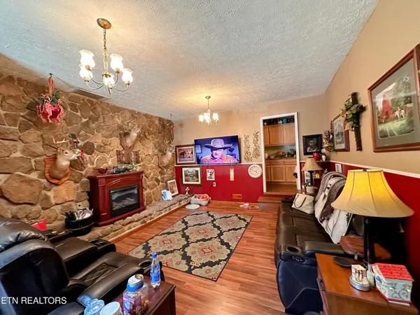 a living room with furniture a flat screen tv and a fireplace