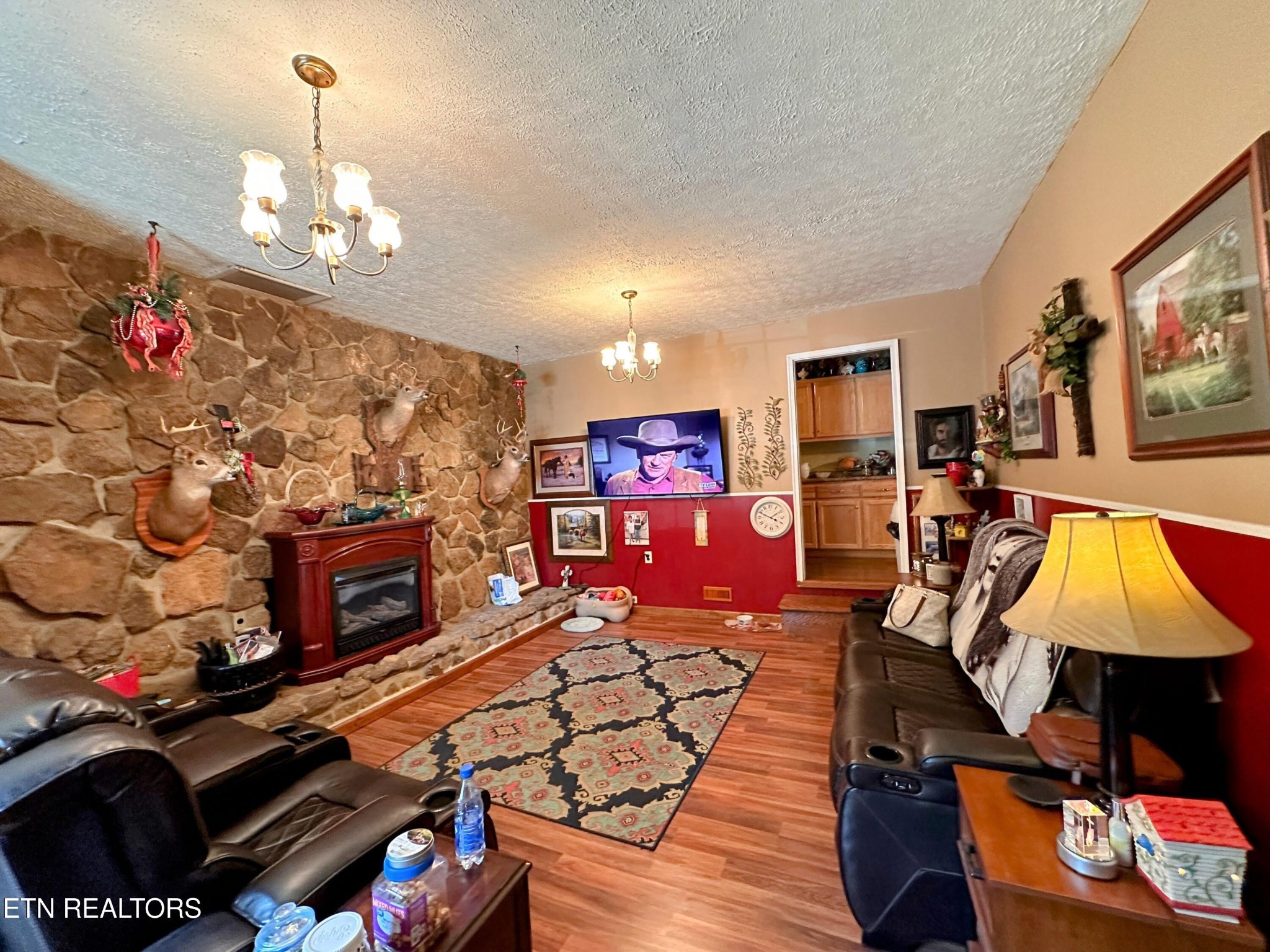 1065 Star Point Road Jamestown, TN 38556 - Photo 21 of 40 a living room with furniture a flat screen tv and a fireplace