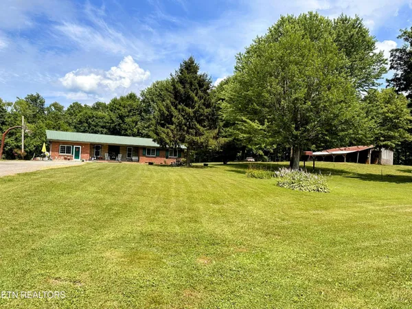 a front view of house with yard and trees