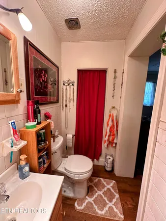 a bathroom with a toilet a sink and a shower