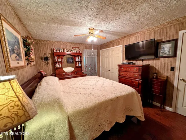 a bedroom with a bed and a flat screen tv