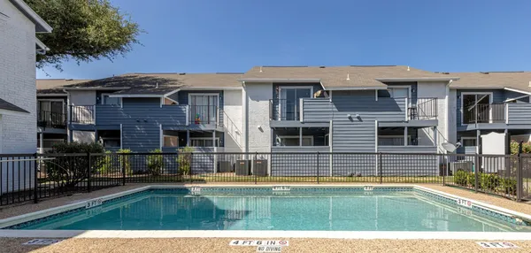 a view of a house with a backyard and a tub