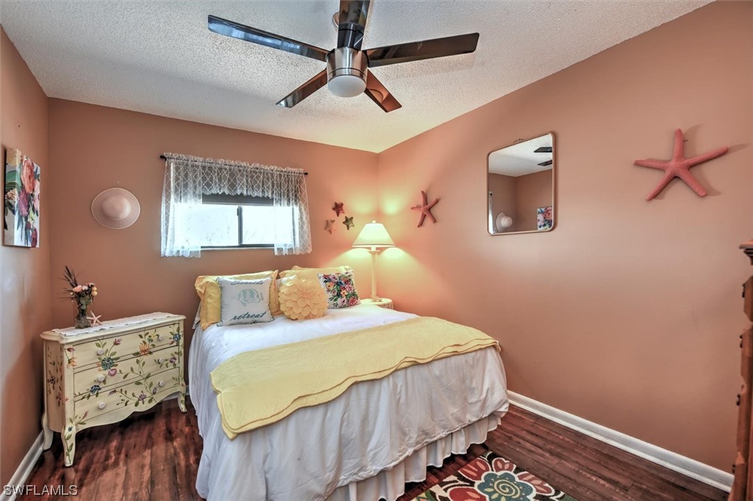 13260 Broadhurst Loop Fort Myers, FL 33919 - Photo 20 of 25 a bedroom with a bed and wooden floor