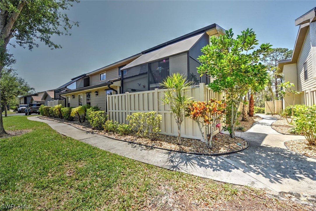13260 Broadhurst Loop Fort Myers, FL 33919 - Photo 3 of 25 a front view of a house with a yard and outdoor seating