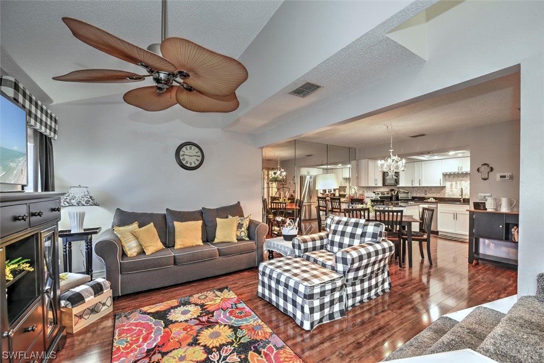 13260 Broadhurst Loop Fort Myers, FL 33919 - Photo 5 of 25 a living room with furniture kitchen view and a chandelier